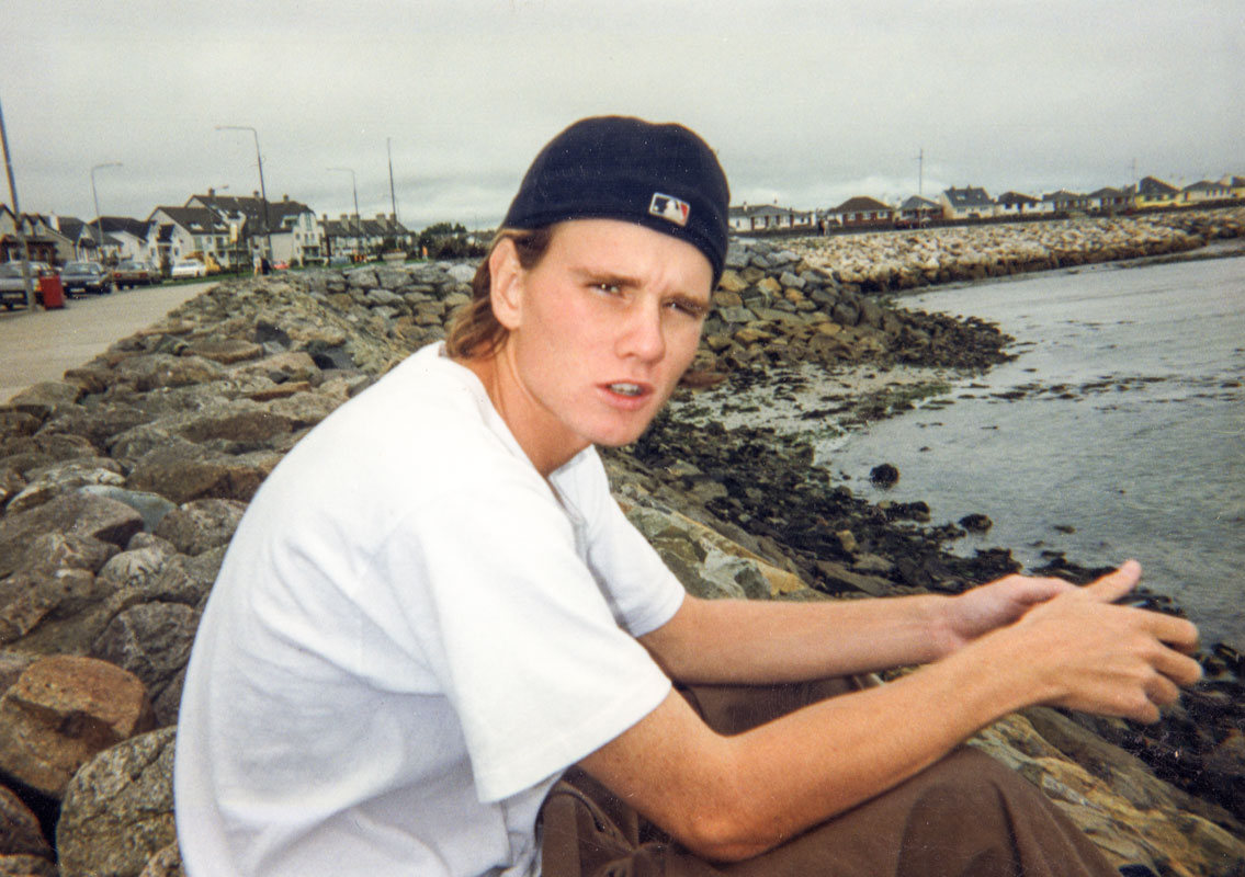 Casey sitting on rocky beach